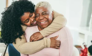 Daughter smiling and hugging mother
