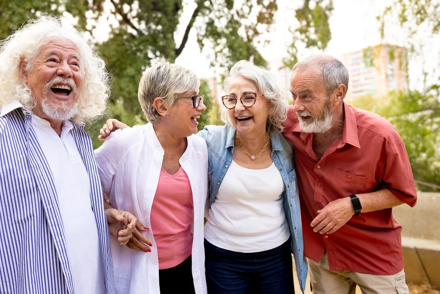 Group of older adults smiling outdoors