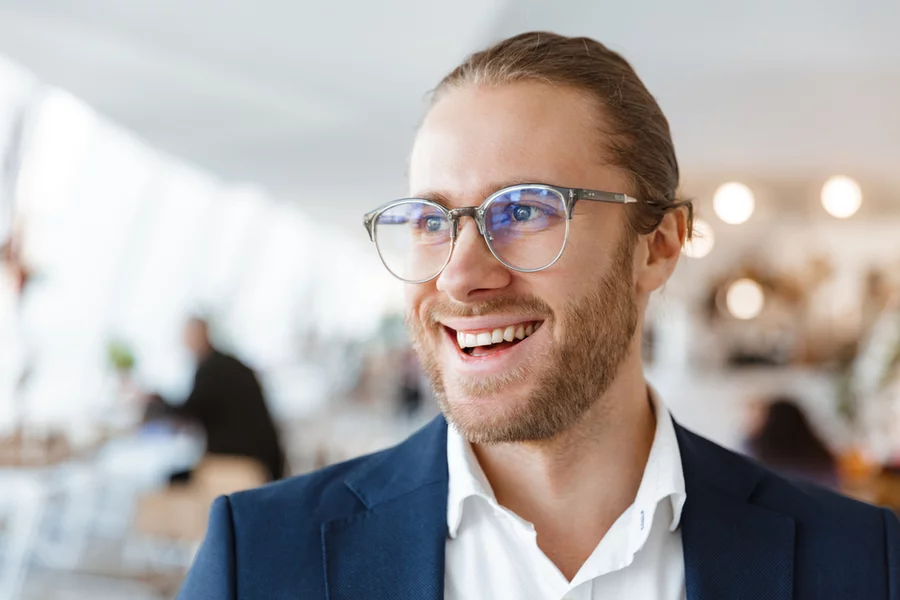 Cheerful businessman smiling in an indoor setting