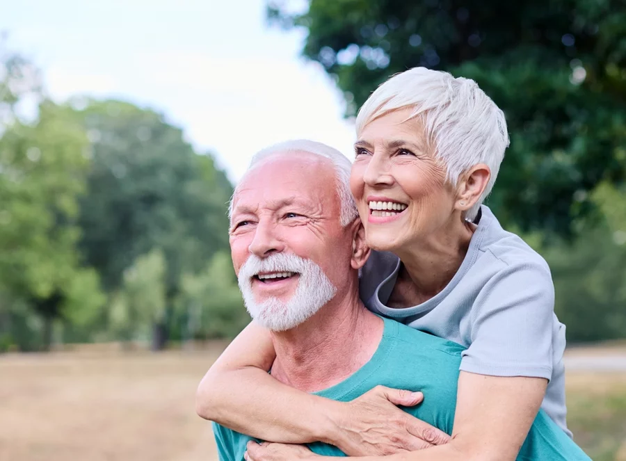 Active senior couple having fun together in the park